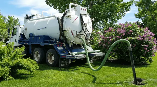 Professional vacuum truck performing residential drainage and septic maintenance in New Orleans, LA