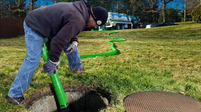 Service technician performing residential septic pumping and drainage maintenance in New Orleans, LA